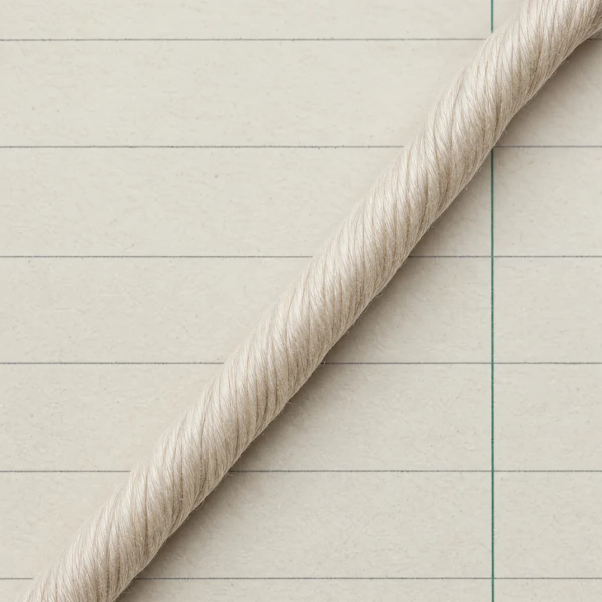 Extreme close-up of a smooth, tightly twisted long-staple cotton yarn with almost no surface hairs.