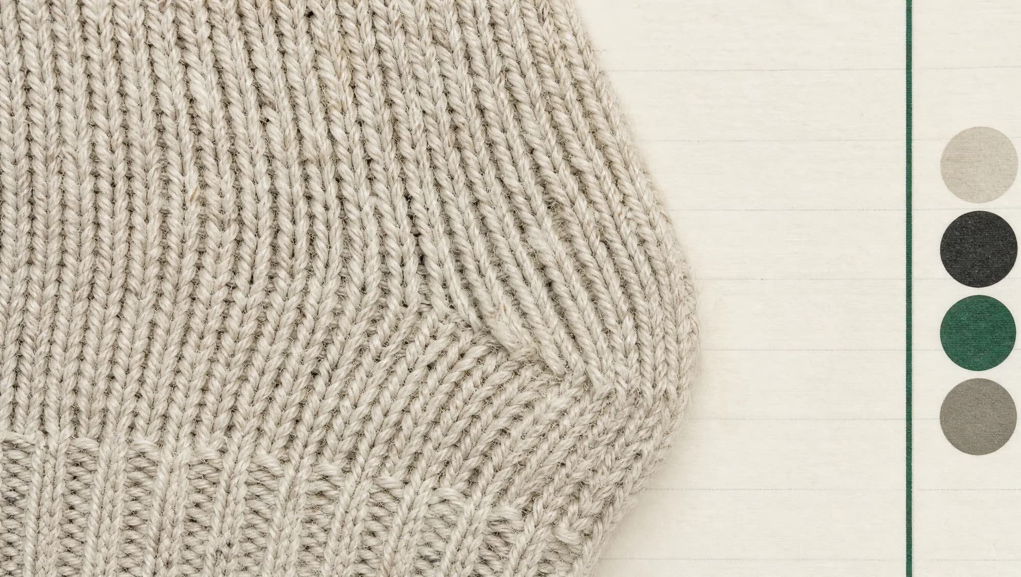 Extreme macro of a knitted sock face filling the frame, with individual loops and yarn plies clearly resolved.